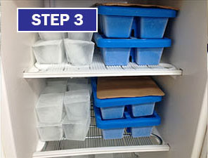 A shelf with two shelves and three trays of food.